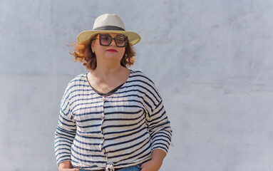 Fashionable lady in stripped jacket, casual fashion for plus size women. Wardrobe ideas concert