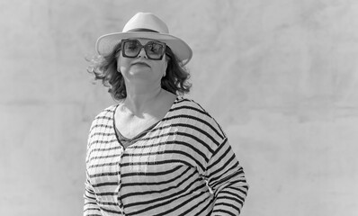 Fashionable lady in stripped jacket, casual fashion for plus size women. Wardrobe ideas concert