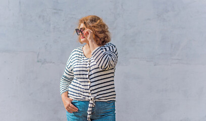 Fashionable lady in stripped jacket, casual fashion for plus size women. Wardrobe ideas concert