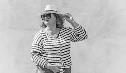 Fashionable lady in stripped jacket, casual fashion for plus size women. Wardrobe ideas concert