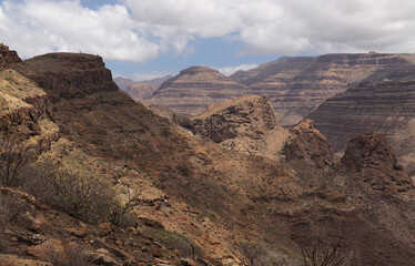 Gran Canaria, landscape of the southern part of the island along Barranco de Arguineguín steep and deep ravine
with vertical rock walls, circular hiking route visiting Elephant rock arch 