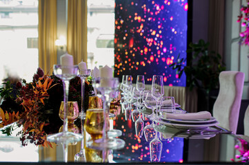 Arranged table with plates and glasses on a wedding reception