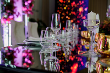 Arranged table with plates and glasses on a wedding reception