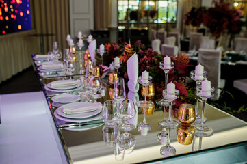 Arranged table with plates and glasses on a wedding reception