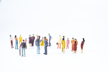 Group of miniature people meeting on white background. - obrazy, fototapety, plakaty