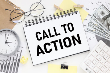 Call to Action. open notepad with text on white background and white keyboard and financial charts