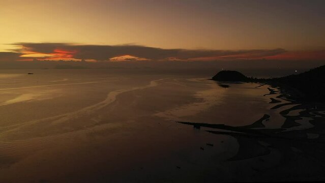 DRONE Flight from sunset ocean towards beach at Nathon area at Koh Samui island - 4 K Film footage - Thailand