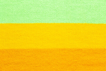 multi colored background. knitted wool fabric texture with stripes