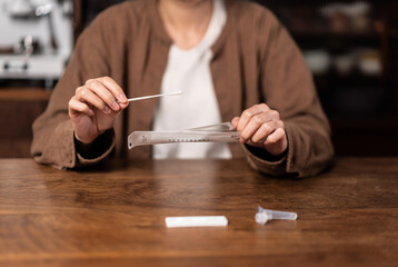 Close up of a person demonstrating tools of coronavirus covid-19 rapid antigen home test