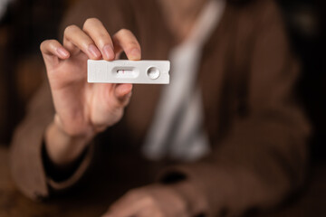 Close up of holding express antigen covid test, negative result	