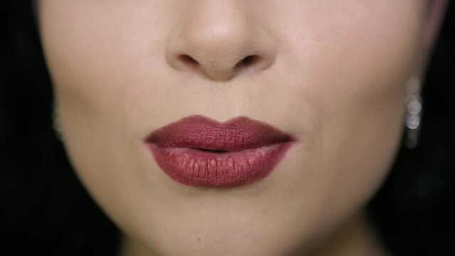 Girl with beautiful lips speaks to the camera