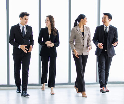 Group Of Young Happy Asian Male And Female Professional Successful Businessman And Businesswoman Colleagues Partnership Teamwork In Formal Business Suit Smiling Walking Side By Side Forward Together