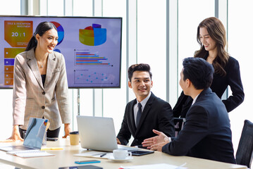 Asian professional successful businesswoman in formal suit standing showing presenting explaining...