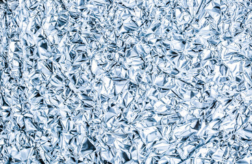 Abstract background shimmering texture metallic glitter foil. Crumpled foil as an unusual background.