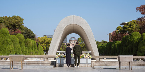 Memorial Cenotaph in Hiroshima Peace Memorial Park and tourists　原爆死没者慰霊碑と観光客 広島平和記念公園 - obrazy, fototapety, plakaty