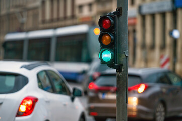 traffic light on the street junction with beautiful bokeh, city with cars in the background