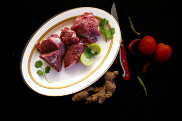 Fresh Beef Steaks decorated with vegetables and herbs on a white plate,Selective focus.