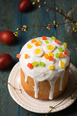 Easter cakes decorated with candied fruits and sweets on a wooden background