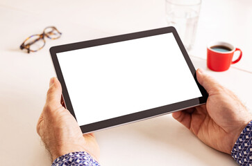 Man’s hands holding tablet with blank screen - background. Free copy (text) space.
