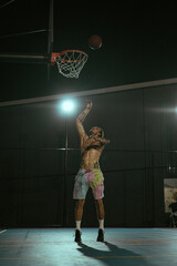 Obraz premium Friends play basketball. Young men play basketball in the street.