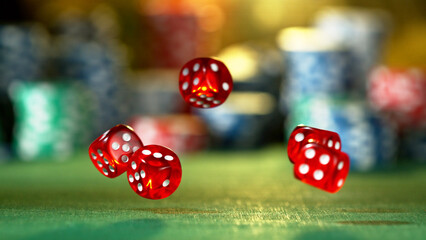 Red dice rotating in the air, poker chips on background.