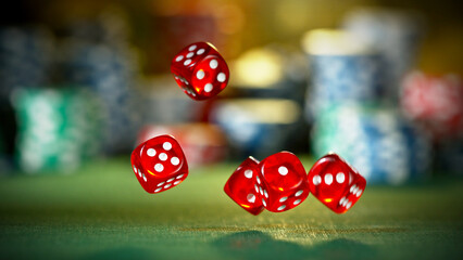 Red dice rotating in the air, poker chips on background.
