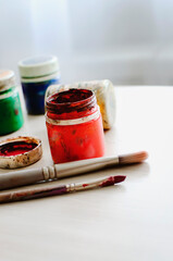 Used gouache in jars and brushes for painting pictures.