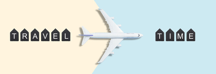 Traveling concept , wooden cubes with TRAVEL TIME words and airplane model