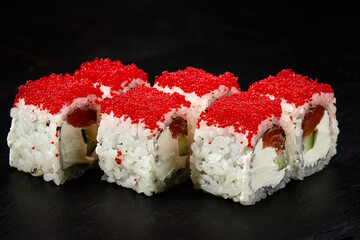 Sushi. Philadelphia roll with fresh salmon, cucumber, avocado, cream cheese, tobiko red caviar