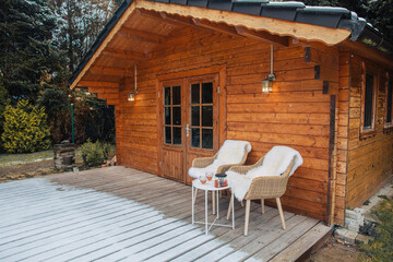 Nice wooden hut in a garden with snow. Garden shed with chairs in winter. Winter mood. Drinking tea...