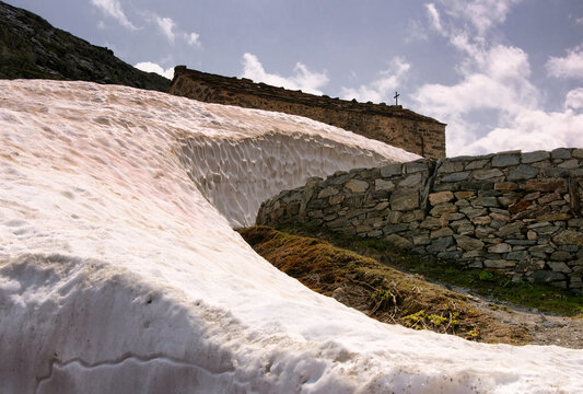 Snow drift next to a church, Great St Bernard Pass, Switzerland