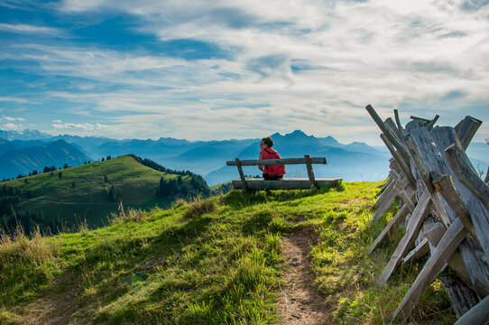Rear view of a woman sitting on a bench looking at view, Mt Rigi, Switzerland