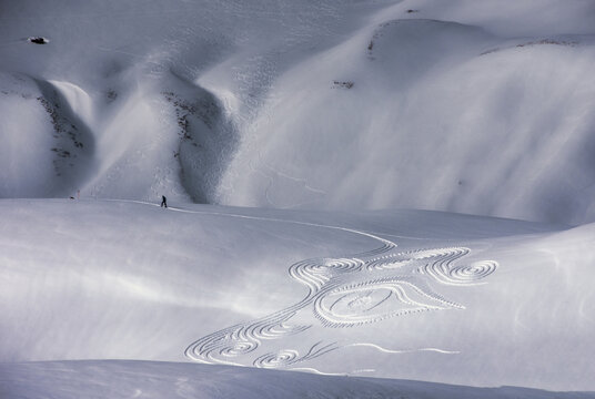 Aerial view of man walking near artwork in the snow, Melchsee Frutt, Kerns, Obwalden, Switzerland