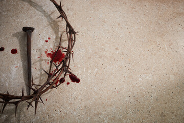 Easter concept. Crown of thorns with Nail and blood drops on a stone background.