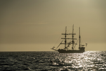pirate vessel silhouette at sunset
