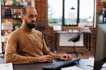 Fintech company office worker brainstorming business investment ideas and project management chart. Executive assistant developing accounting financial documentation while at desk in workspace.