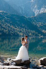 Young wedding couple near lake in Tatra mountains, Poland