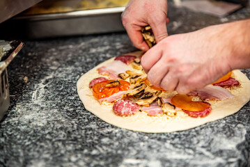 hand of chef baker making pizza at kitchen. The process of making pizza. cooking italian pizza