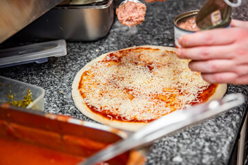 hand of chef baker making pizza at kitchen. The process of making pizza. cooking italian pizza