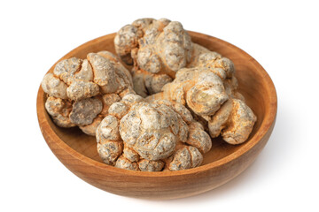 Dried notoginseng roots in the wooden bowl, isolated on the white background.