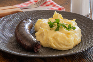 black pudding cooked with mashed potatoes on a plate
