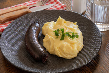 black pudding cooked with mashed potatoes on a plate