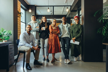 Fototapeta premium Diverse business team smiling at the camera in an office