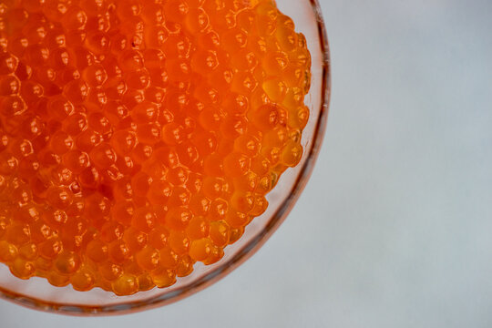 Close-up overhead view of red trout caviar in a glass dessert coupe