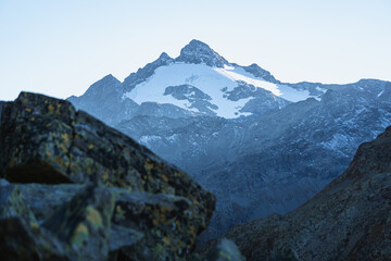 Fototapeta premium Pizzo ferrè with its glacier dominates the upper Spluga valley, on the border between Italy and Switzerland, near the town of Madesimo, Italy - September 2021.