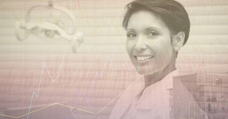 Composite image of financial data processing against african american female doctor smiling