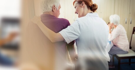 Blur effect with copy space against female health worker helping senior man at retirement home
