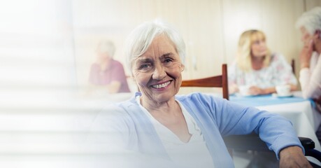Blur effect with copy space against portrait of caucasian senior woman smiling at retirement home