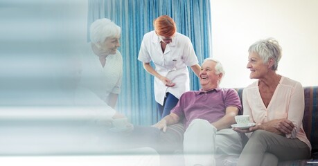 Blur effect with copy space against group of senior people having coffee together at retirement home