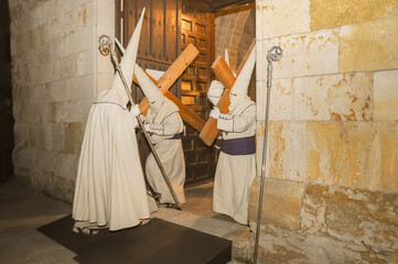 Holy Week in Zamora, Spain. Procession of the Penitential Brotherhood of Jesús Yacente. The penitents leave the temple carrying crosses on Holy Thursday night.